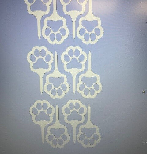 CNC machine-cut paw print signs